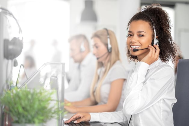 woman smiling holding phone headset