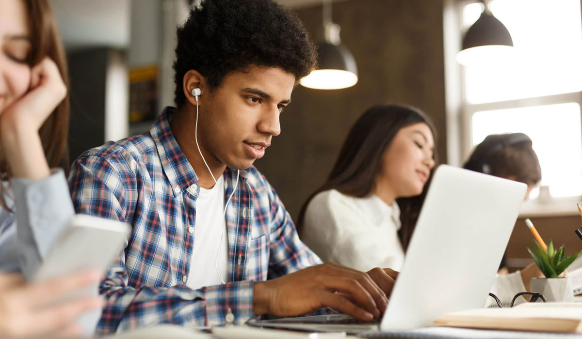 college student using laptop in classroom