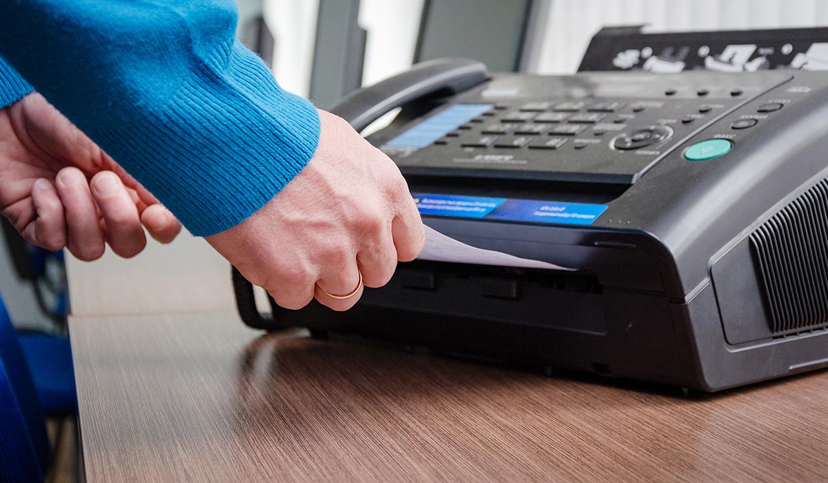 man using fax machine