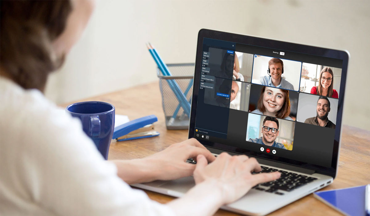 woman using sangoma chat on her laptop to video conference with other people