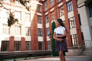 orange-colored-building-school-girl-in-uniform-is-2023-11-29-00-47-11-utc-1