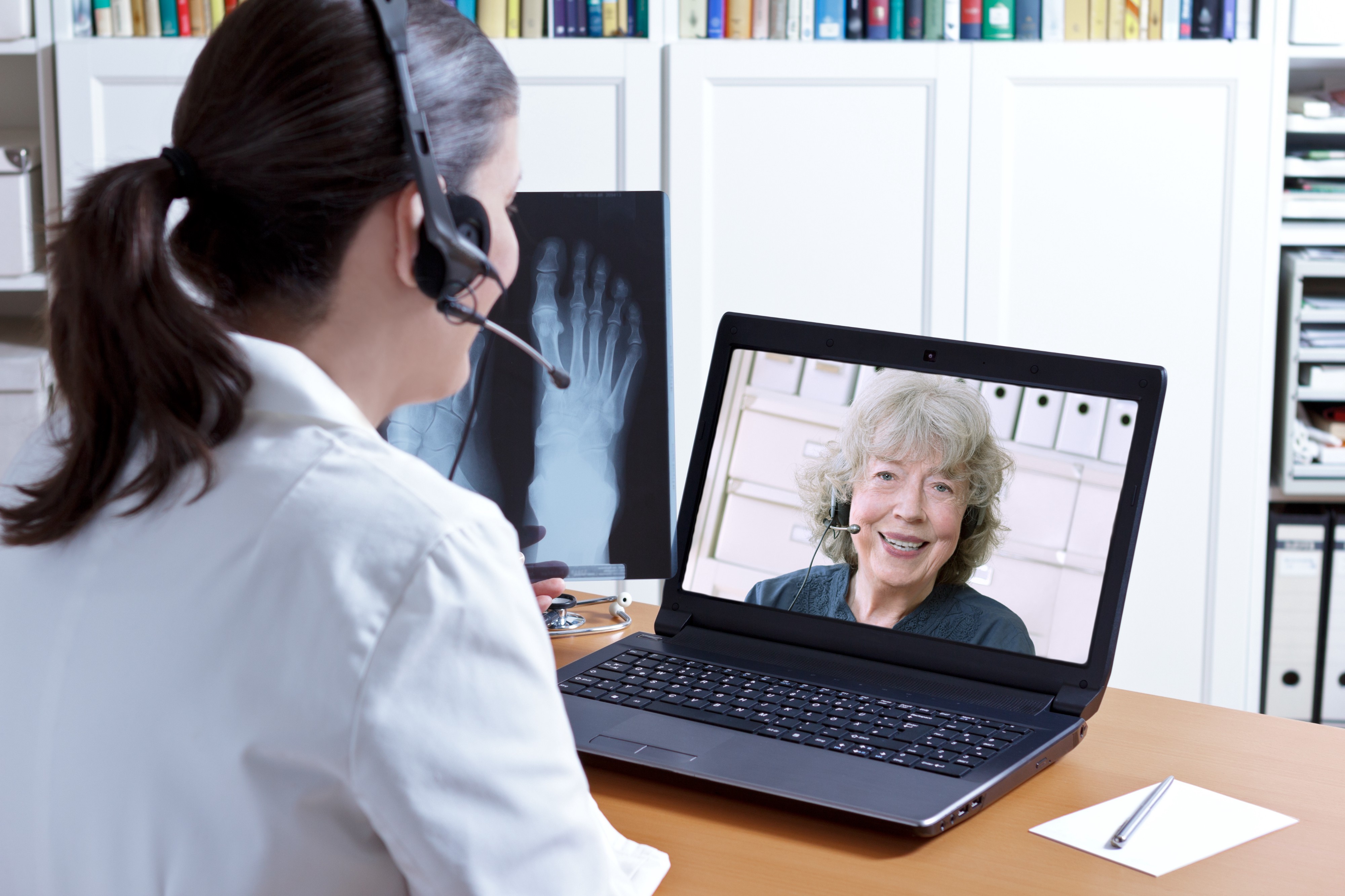 Doctor chatting with patient on laptop