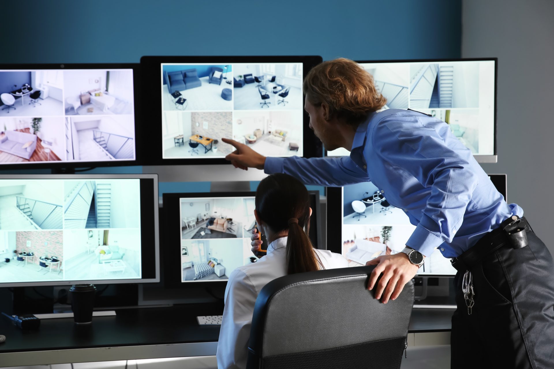 Security guards monitoring modern CCTV cameras in surveillance room