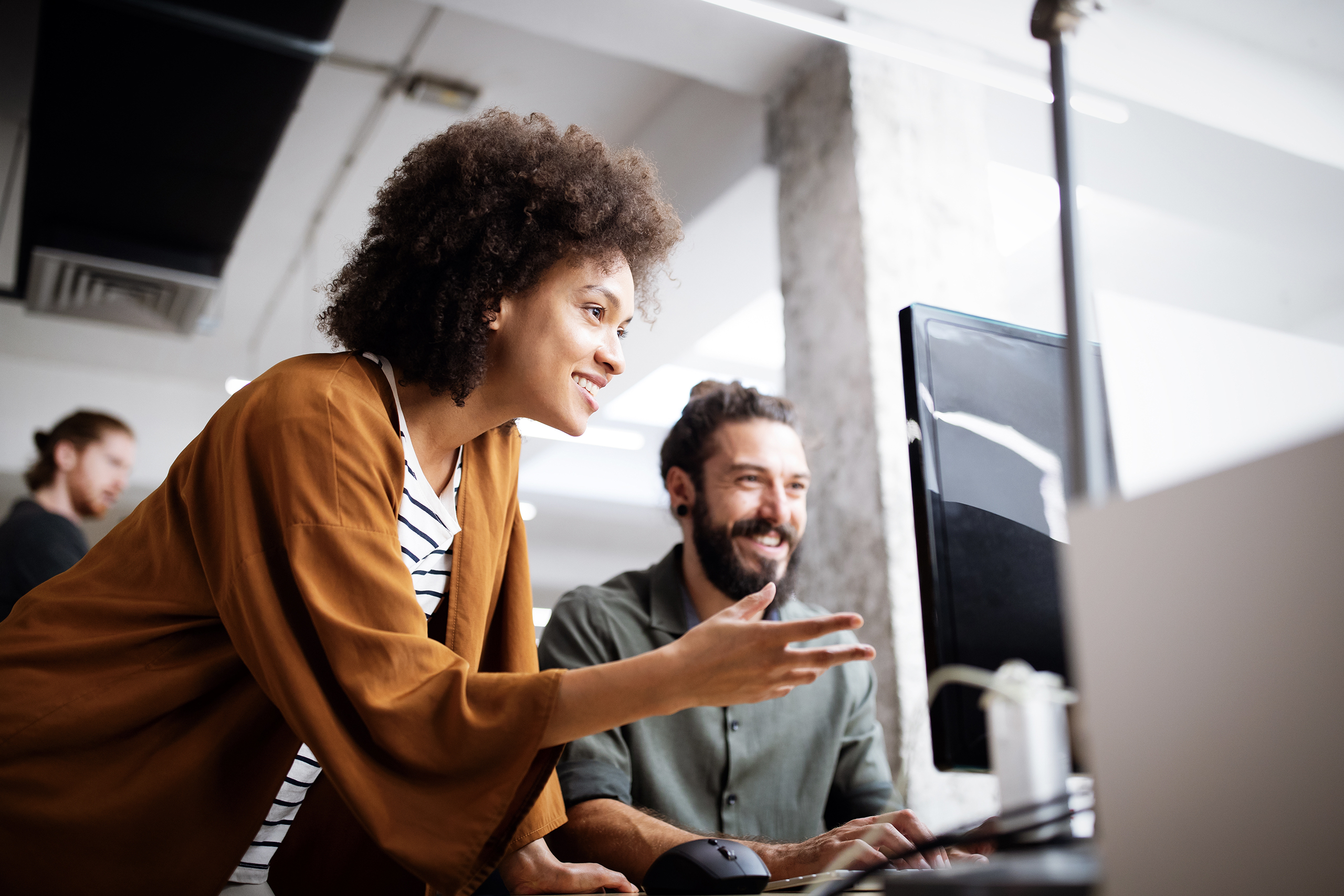 Woman helping man with computer IT problem