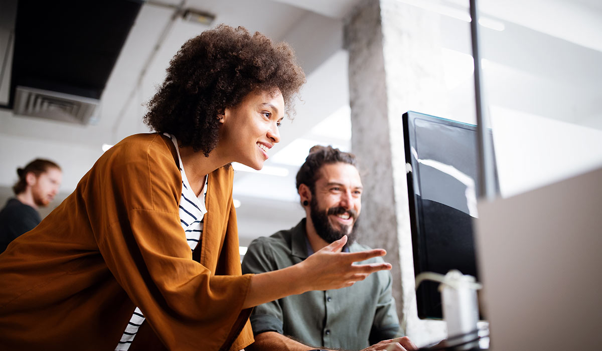 man and woman working together on a computer