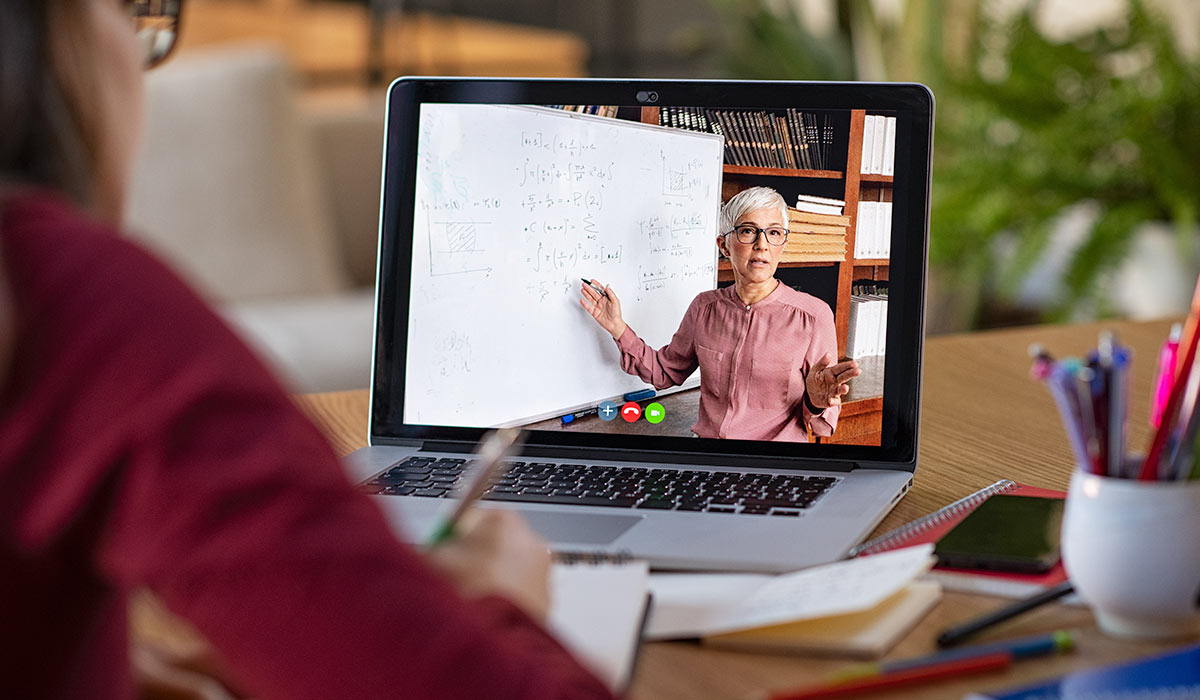 student watching teacher on laptop