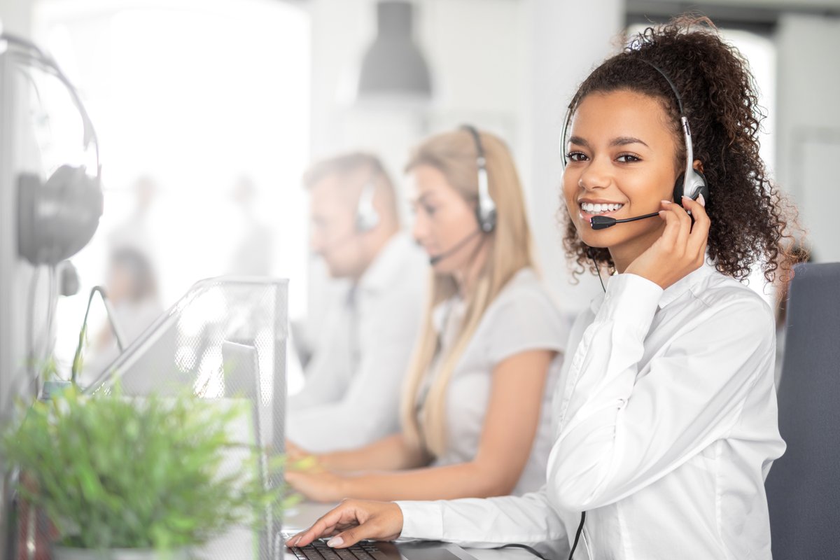 woman smiling holding phone headset