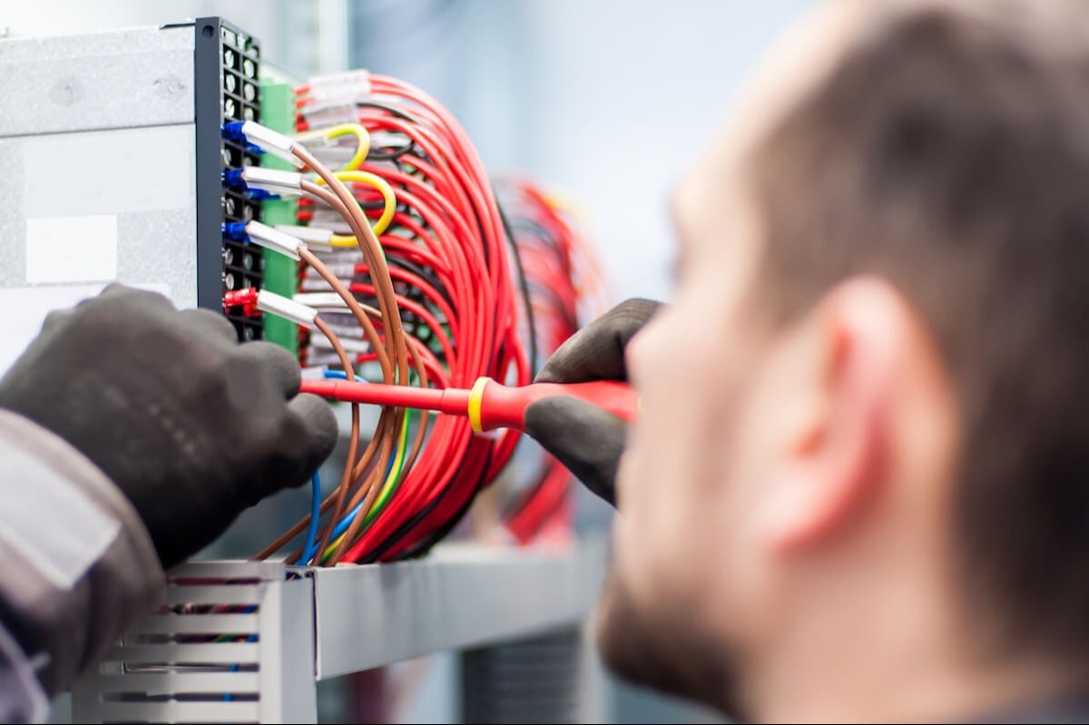 man installing network cables