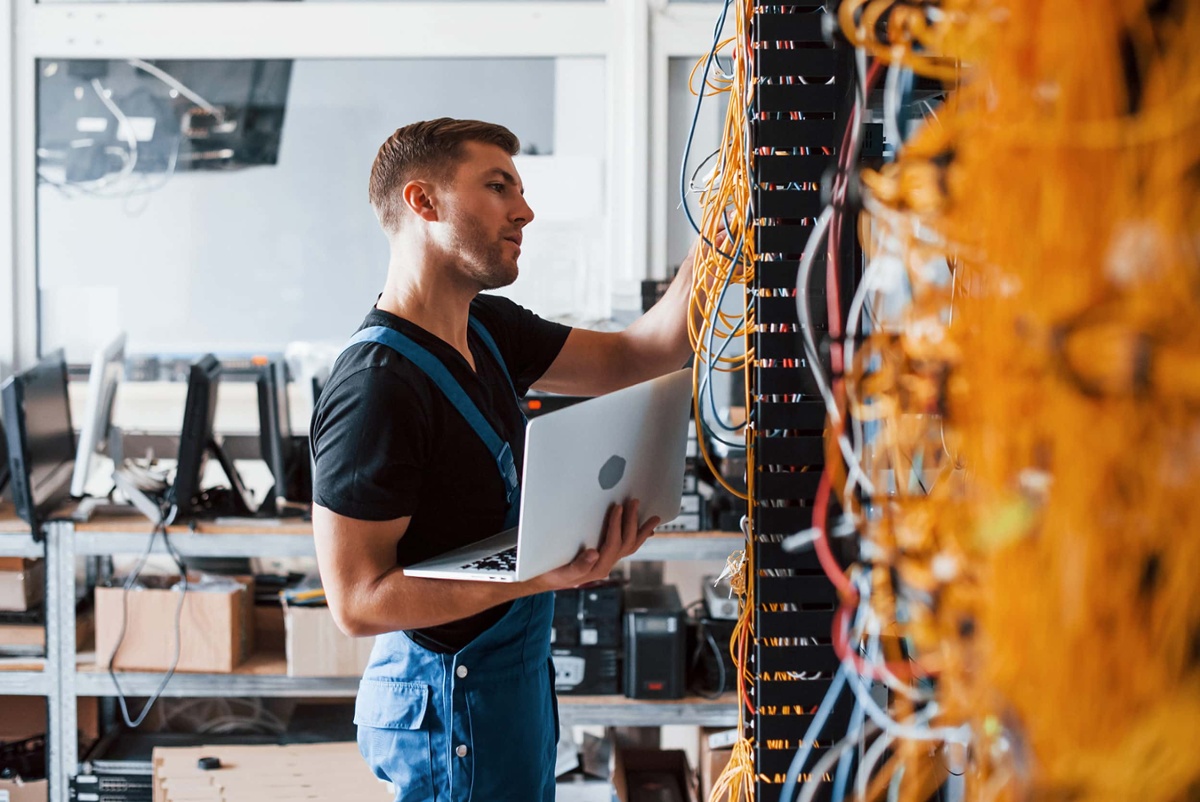 man setting up network cables