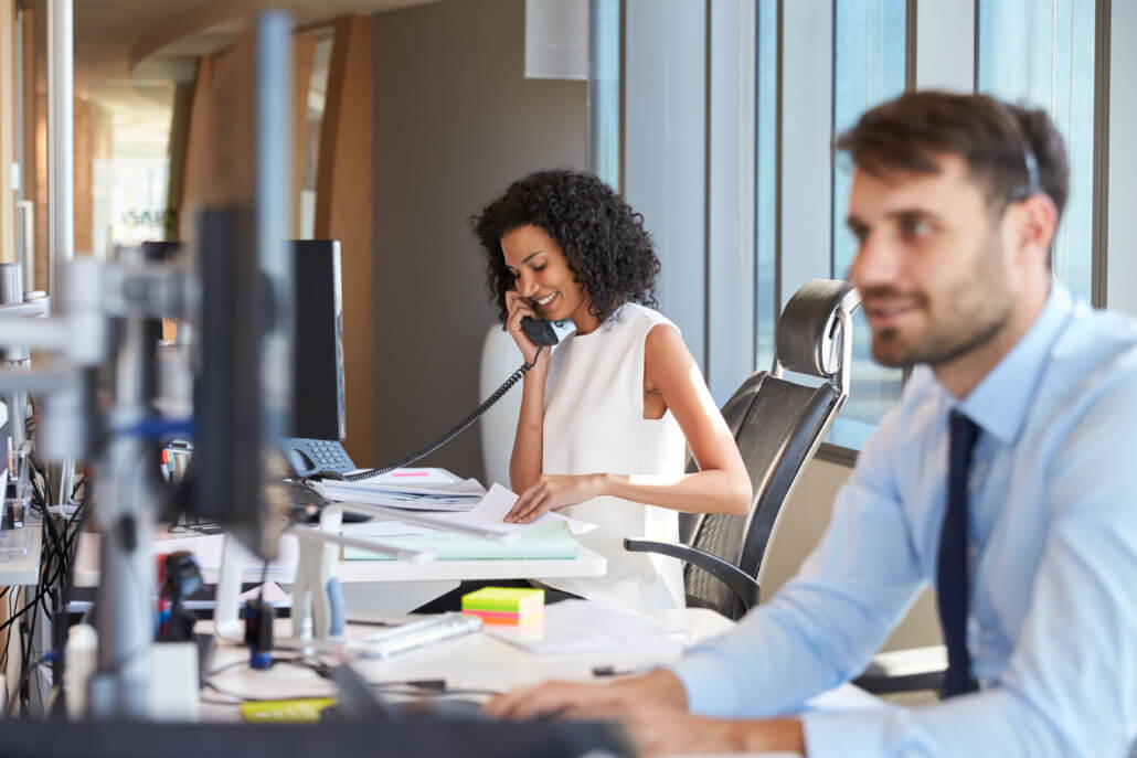 woman talking on phone in office environment