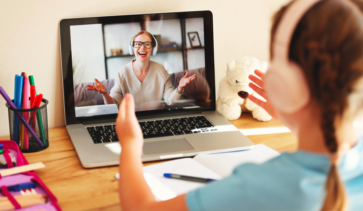 Teacher on laptop communicating with student at home