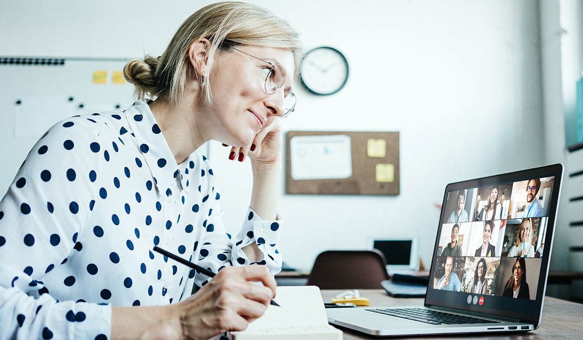 teacher on a call with students using a laptop