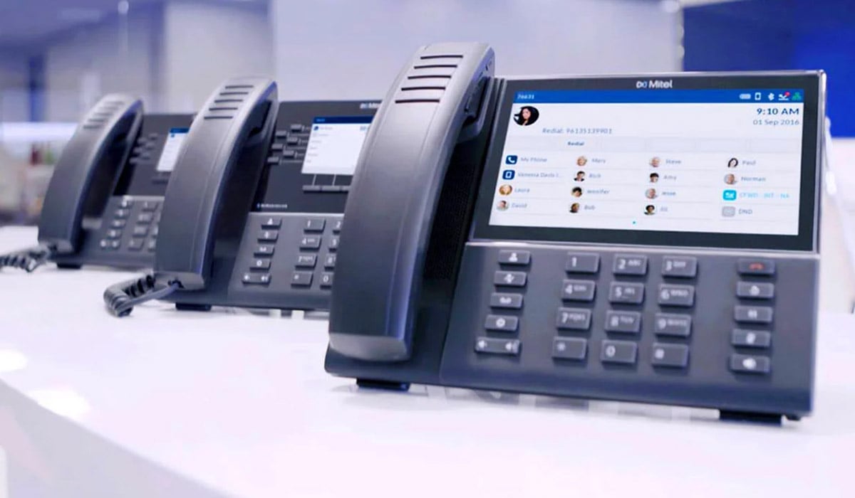 row of mitel phones on desk