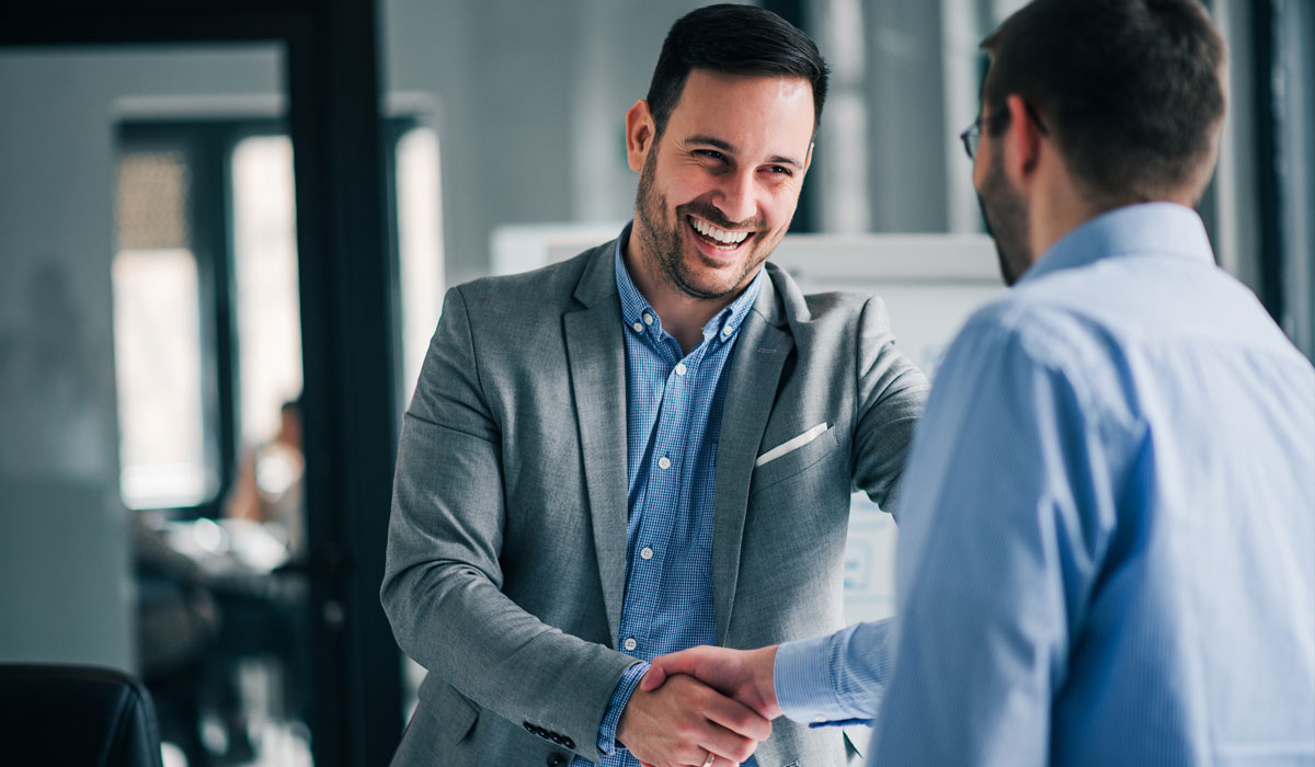 two guys shaking hands in the office