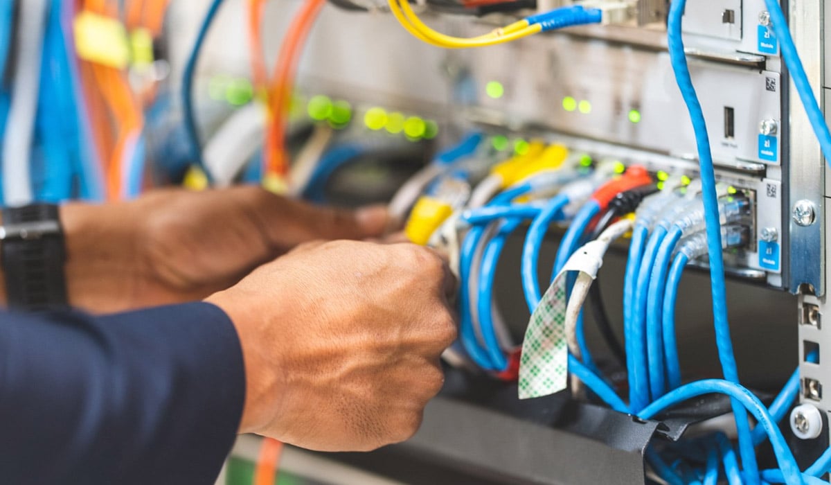 upclose of man working on network cabling