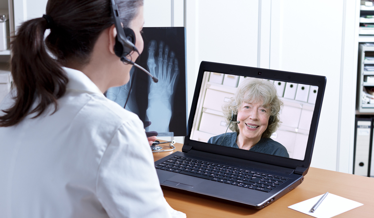 female doctor chatting with patient over web conference