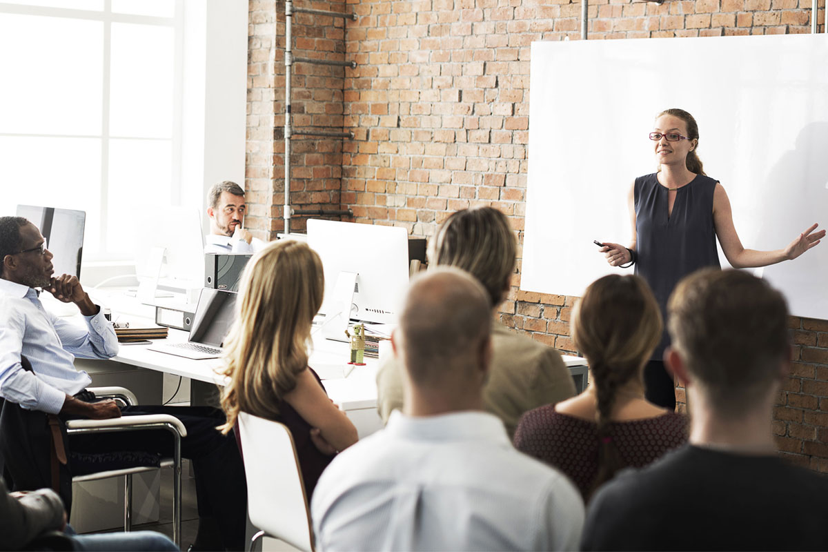 group of people in front of a business presentation