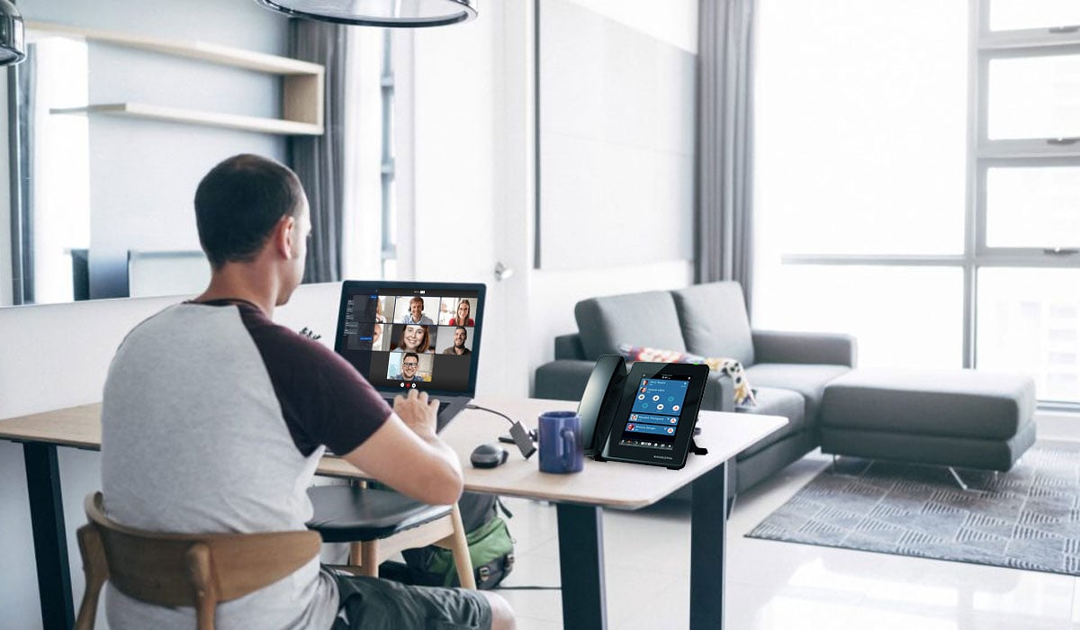 man working from home using conference call software on laptop